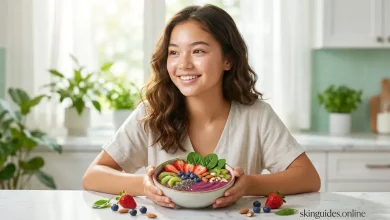 Smiling teenage girl with clear skin holding a colorful smoothie bowl topped with berries, kiwi, spinach, nuts and seeds, representing the best diet for teenager's skin
